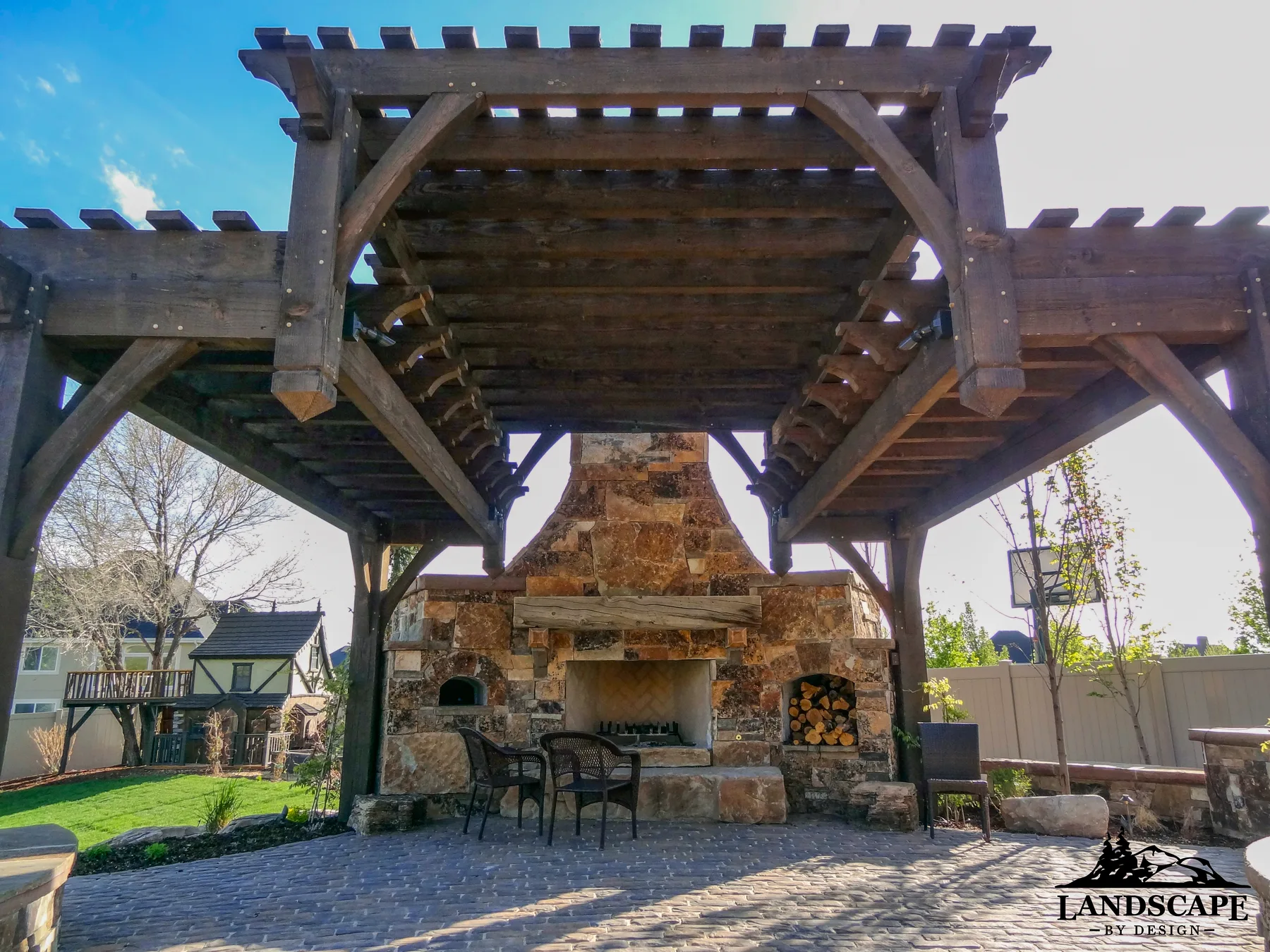 Grand pergola structures paired with fire features for year-round enjoyment.