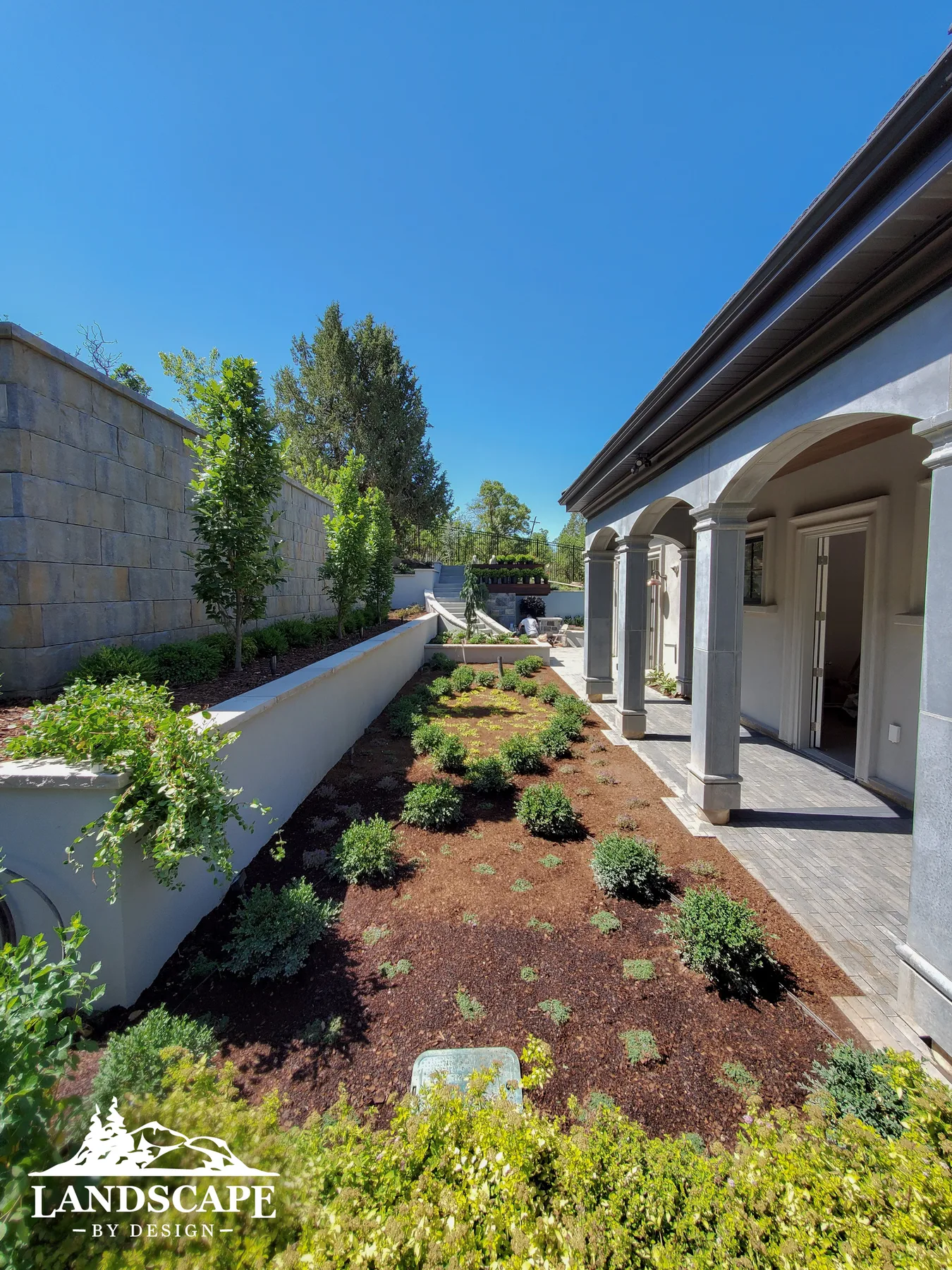 Planting Along Walkway With Pillars